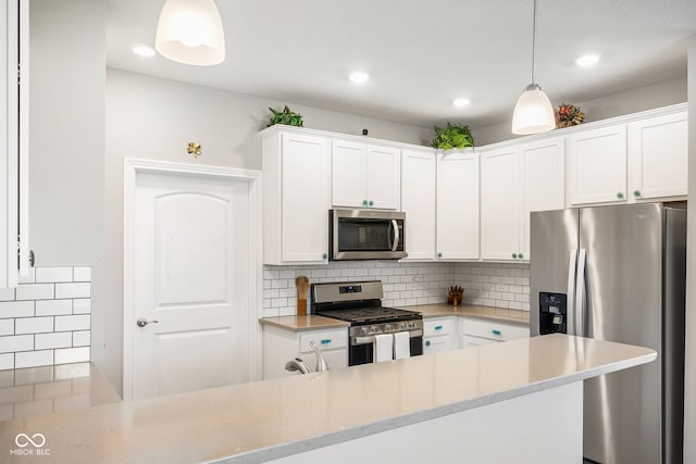 8842 Twain Ln, Indianapolis, IN 46239 - kitchen with appliances with stainless steel finishes, white cabinetry, backsplash, pendant lighting, and recessed lighting