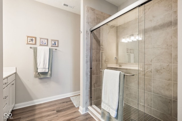 8842 Twain Ln, Indianapolis, IN 46239 - full bathroom featuring vanity, wood finished floors, and a shower stall