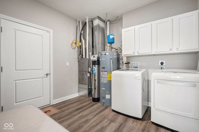 8842 Twain Ln, Indianapolis, IN 46239 - washroom featuring water heater, cabinet space, dark wood finished floors, washing machine and clothes dryer, and heating unit