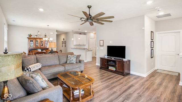 8842 Twain Ln, Indianapolis, IN 46239 - living room with ceiling fan, light wood-type flooring, recessed lighting, and a chandelier