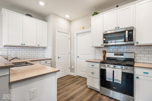 8842 Twain Ln, Indianapolis, IN 46239 - kitchen featuring appliances with stainless steel finishes, recessed lighting, dark wood-style flooring, white cabinets, and backsplash