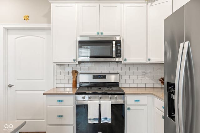 8842 Twain Ln, Indianapolis, IN 46239 - kitchen with appliances with stainless steel finishes, light countertops, white cabinetry, and tasteful backsplash