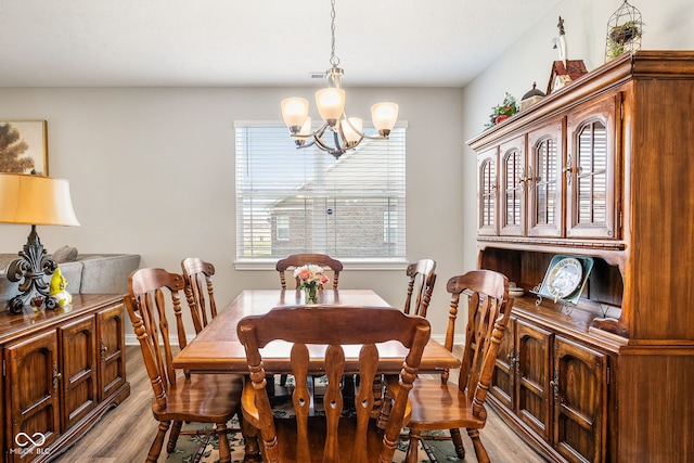 8842 Twain Ln, Indianapolis, IN 46239 - dining space featuring a chandelier and light wood-style flooring