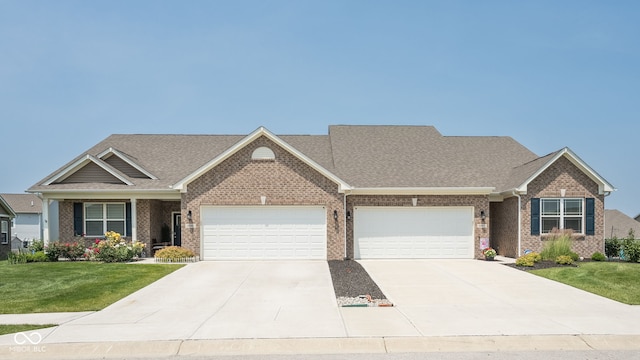 8842 Twain Ln, Indianapolis, IN 46239 - view of front of house with brick siding, an attached garage, a front yard, concrete driveway, and roof with shingles