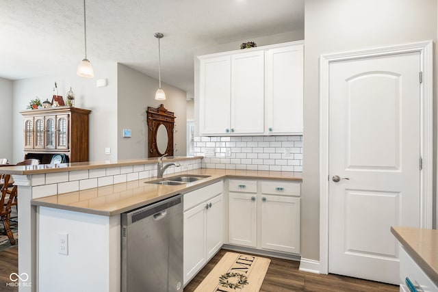 8842 Twain Ln, Indianapolis, IN 46239 - kitchen with stainless steel dishwasher, dark wood-style flooring, decorative backsplash, a peninsula, and decorative light fixtures
