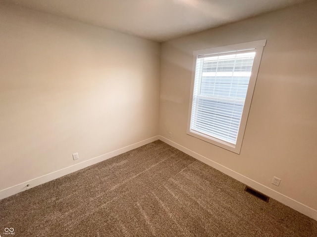 1628 Spann Ave, Indianapolis, IN 46203 - empty room with baseboards and dark colored carpet
