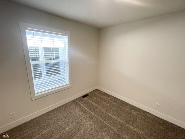 1628 Spann Ave, Indianapolis, IN 46203 - empty room with baseboards and dark carpet