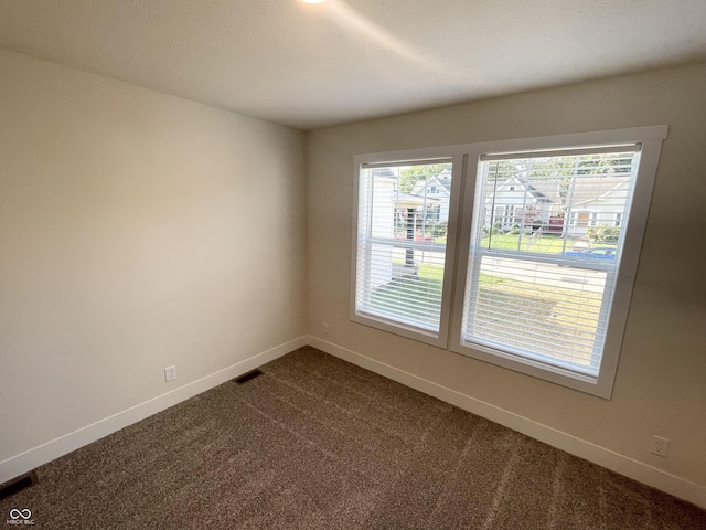 1628 Spann Ave, Indianapolis, IN 46203 - unfurnished room featuring dark carpet and baseboards