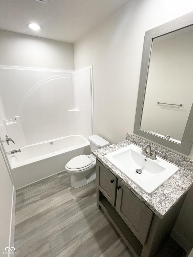 1628 Spann Ave, Indianapolis, IN 46203 - full bath featuring vanity, wood finished floors, and shower / bath combination