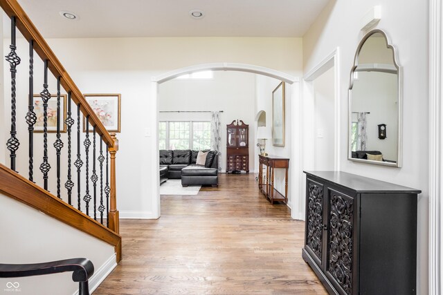 47 Torrey Pine Dr, Brownsburg, IN 46112 - foyer entrance featuring arched walkways, light wood-style flooring, stairway, and recessed lighting