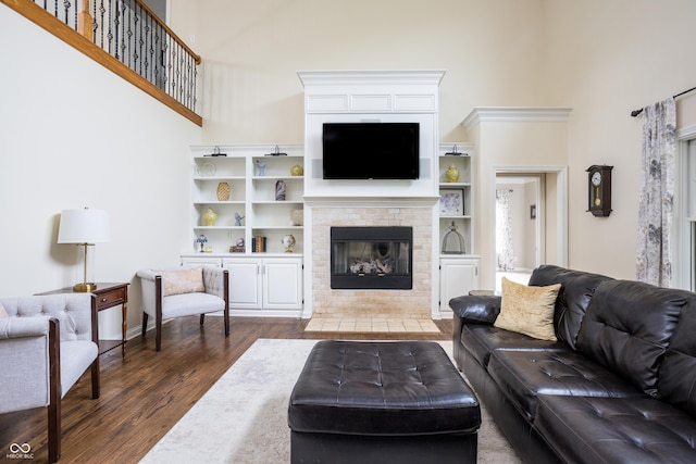 47 Torrey Pine Dr, Brownsburg, IN 46112 - living area featuring a high ceiling, dark wood-style flooring, and a brick fireplace