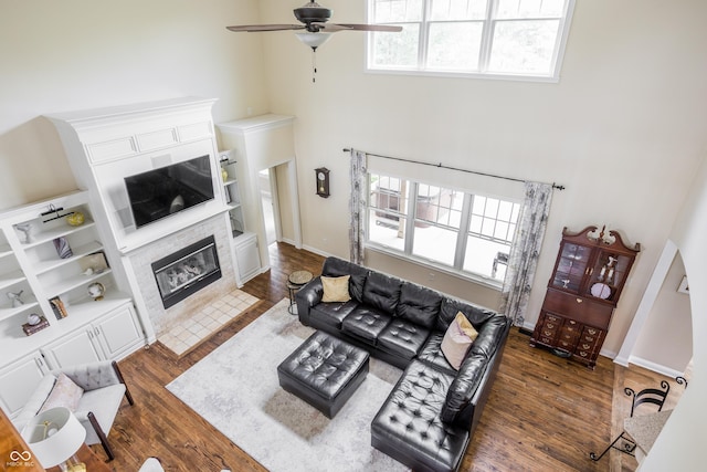 47 Torrey Pine Dr, Brownsburg, IN 46112 - living area featuring a towering ceiling, ceiling fan, dark wood-style floors, and a tile fireplace