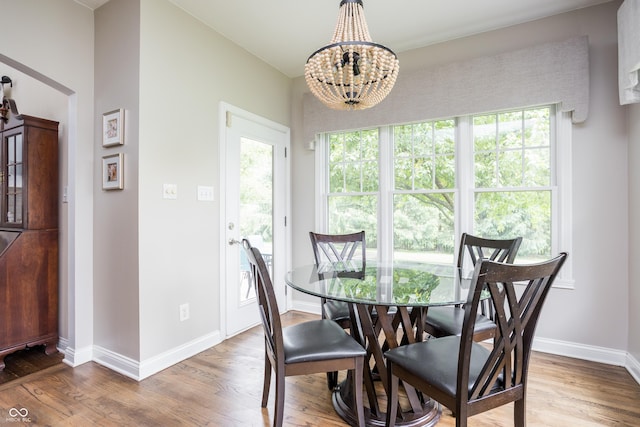 47 Torrey Pine Dr, Brownsburg, IN 46112 - dining room with wood finished floors, a chandelier, and healthy amount of natural light