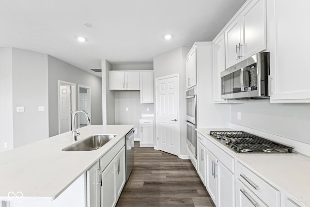 12516 Morning Ridge Way, Noblesville, IN 46060 - kitchen with dark wood-style floors, white cabinets, appliances with stainless steel finishes, recessed lighting, and a center island with sink