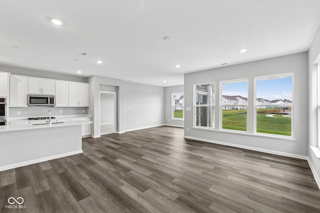 12516 Morning Ridge Way, Noblesville, IN 46060 - kitchen with dark wood-style flooring, light countertops, white cabinets, recessed lighting, and open floor plan