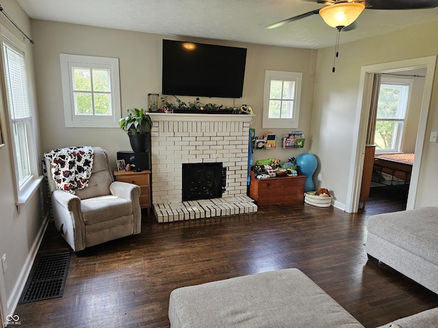 1510 Chester St, Anderson, IN 46012 - living area featuring a ceiling fan, wood finished floors, and a brick fireplace