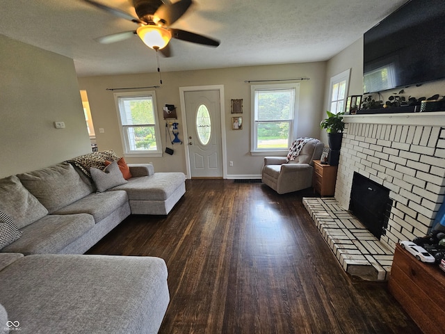 1510 Chester St, Anderson, IN 46012 - living room with wood finished floors, ceiling fan, plenty of natural light, and a brick fireplace