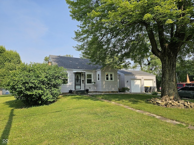 1510 Chester St, Anderson, IN 46012 - view of front of home featuring a front yard, a garage, and a shingled roof