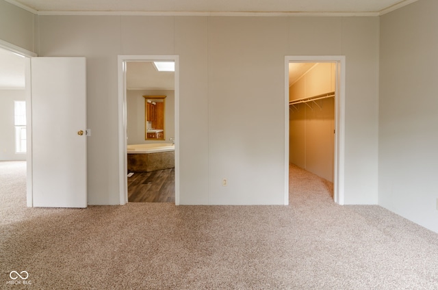 3149 Carson Ave, Indianapolis, IN 46227 - unfurnished bedroom featuring carpet, a walk in closet, crown molding, a closet, and connected bathroom