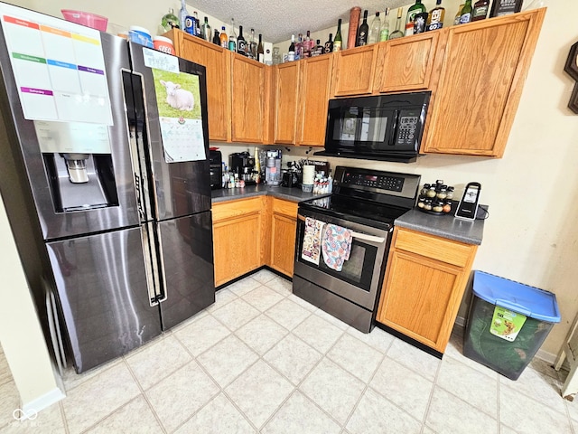 7906 States Bend Ln, Indianapolis, IN 46239 - kitchen with appliances with stainless steel finishes, dark countertops, and a textured ceiling