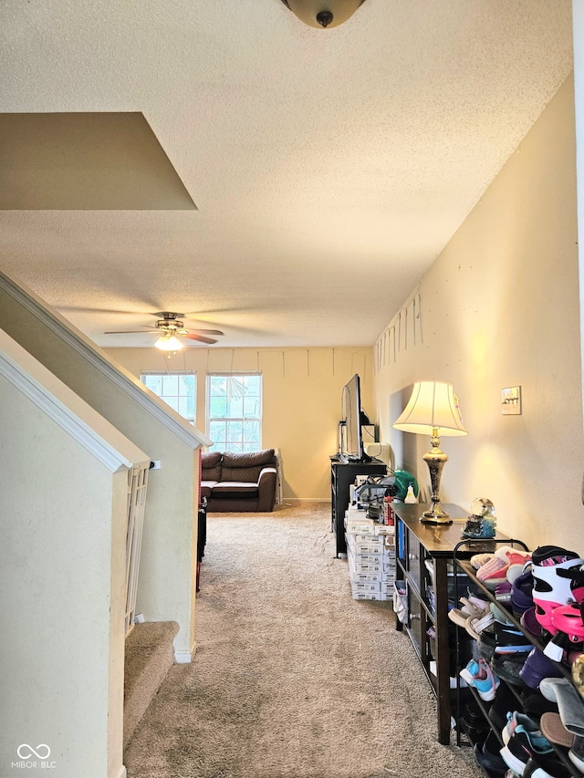 7906 States Bend Ln, Indianapolis, IN 46239 - corridor featuring a textured ceiling, carpet floors, and stairs