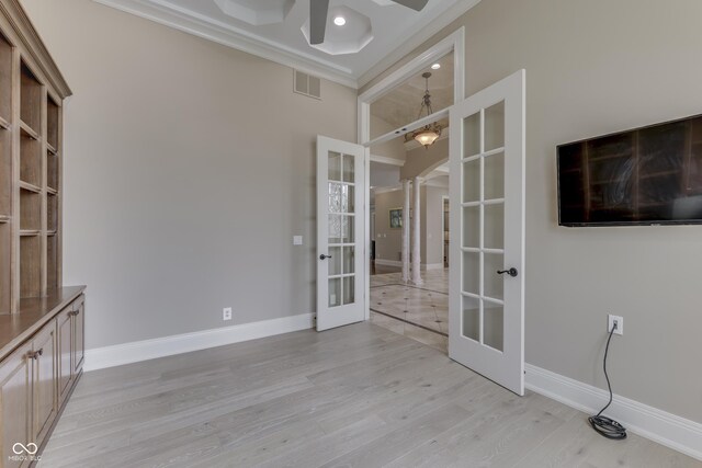 3795 Claybrook Ct, Bargersville, IN 46106 - spare room with french doors, ornamental molding, ceiling fan, ornate columns, and light wood-type flooring