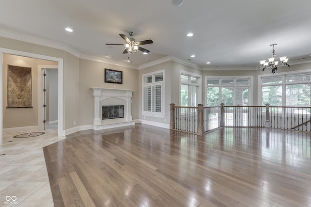 3795 Claybrook Ct, Bargersville, IN 46106 - unfurnished living room featuring a ceiling fan, a chandelier, light wood finished floors, crown molding, and a glass covered fireplace