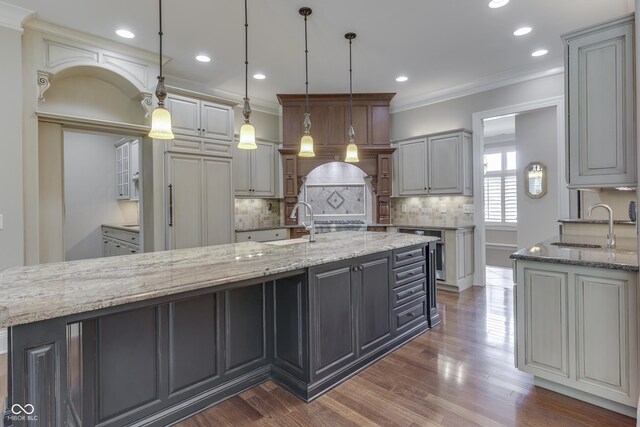 3795 Claybrook Ct, Bargersville, IN 46106 - kitchen featuring tasteful backsplash, crown molding, light stone counters, dark wood-style flooring, and pendant lighting