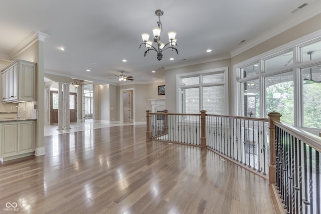 3795 Claybrook Ct, Bargersville, IN 46106 - unfurnished living room featuring crown molding, decorative columns, recessed lighting, a chandelier, and light wood-style floors