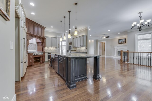 3795 Claybrook Ct, Bargersville, IN 46106 - kitchen with crown molding, a chandelier, tasteful backsplash, recessed lighting, and a fireplace with raised hearth
