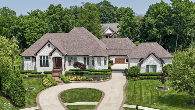 3795 Claybrook Ct, Bargersville, IN 46106 - view of front of property with stone siding, driveway, a front yard, and roof with shingles
