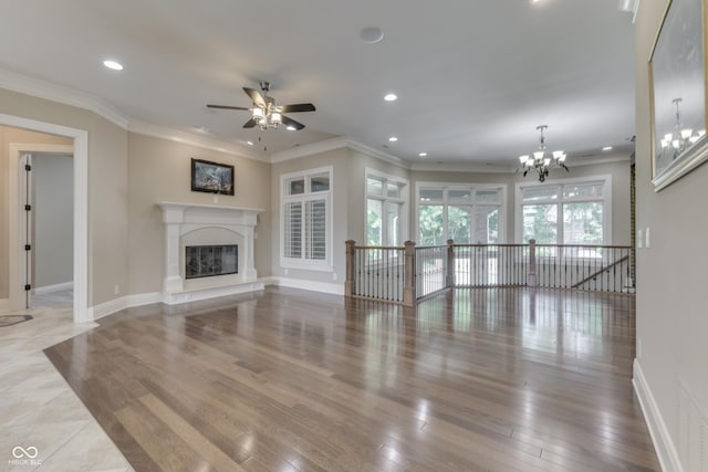 3795 Claybrook Ct, Bargersville, IN 46106 - unfurnished living room featuring ceiling fan, a chandelier, wood finished floors, a glass covered fireplace, and crown molding