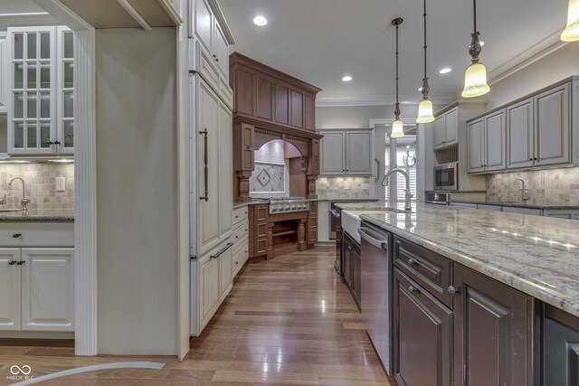 3795 Claybrook Ct, Bargersville, IN 46106 - kitchen with tasteful backsplash, ornamental molding, appliances with stainless steel finishes, wood finished floors, and light stone countertops
