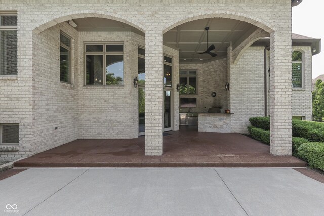 3795 Claybrook Ct, Bargersville, IN 46106 - property entrance with ceiling fan, an outdoor kitchen, and brick siding