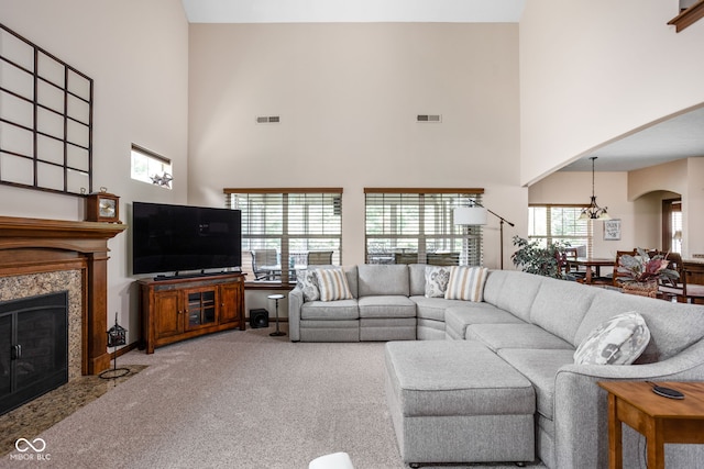 5194 Orahood Ct, Plainfield, IN 46168 - living room featuring a high ceiling, a high end fireplace, carpet flooring, a chandelier, and arched walkways