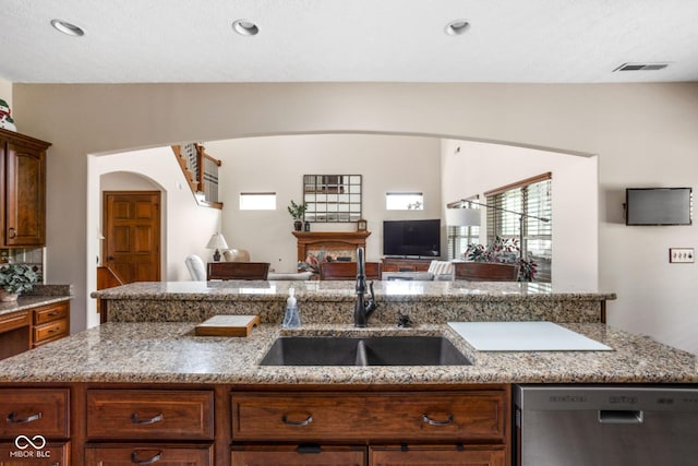 5194 Orahood Ct, Plainfield, IN 46168 - kitchen with dishwasher, arched walkways, open floor plan, light stone counters, and recessed lighting
