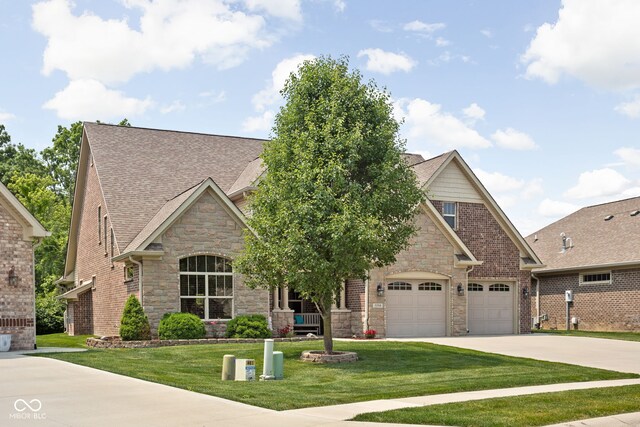 5194 Orahood Ct, Plainfield, IN 46168 - view of front of home with stone siding, concrete driveway, a front yard, and a garage