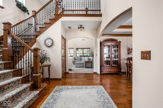 5194 Orahood Ct, Plainfield, IN 46168 - entryway featuring a high ceiling, wood finished floors, arched walkways, and stairs