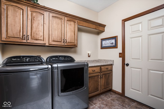 5194 Orahood Ct, Plainfield, IN 46168 - washroom featuring washing machine and clothes dryer, cabinet space, and dark tile patterned flooring