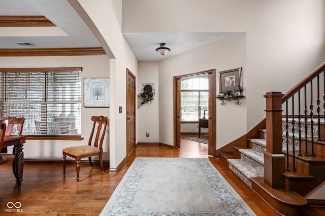 5194 Orahood Ct, Plainfield, IN 46168 - foyer entrance with wood finished floors, stairs, arched walkways, and ornamental molding