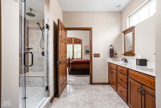 5194 Orahood Ct, Plainfield, IN 46168 - ensuite bathroom featuring double vanity, a shower stall, plenty of natural light, and tile patterned floors