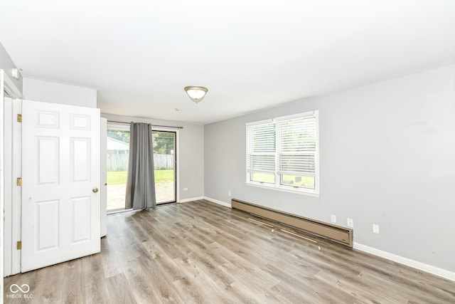 1543 W 79th St, Indianapolis, IN 46260 - spare room with baseboard heating and light wood-style flooring