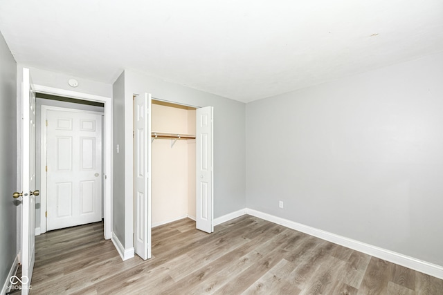 1543 W 79th St, Indianapolis, IN 46260 - unfurnished bedroom featuring light wood-type flooring and a closet