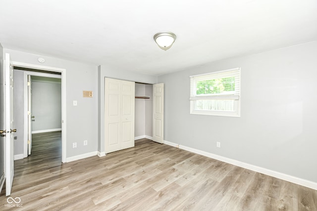 1543 W 79th St, Indianapolis, IN 46260 - unfurnished bedroom featuring light wood-type flooring and a closet