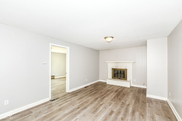 1543 W 79th St, Indianapolis, IN 46260 - unfurnished living room featuring light wood finished floors and a fireplace