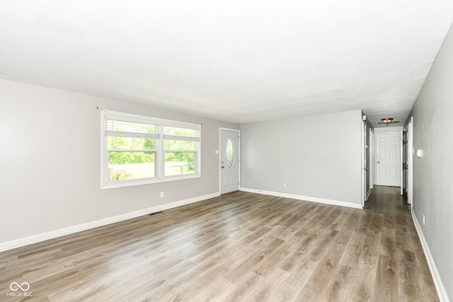 1543 W 79th St, Indianapolis, IN 46260 - unfurnished living room featuring light wood-style floors and baseboards
