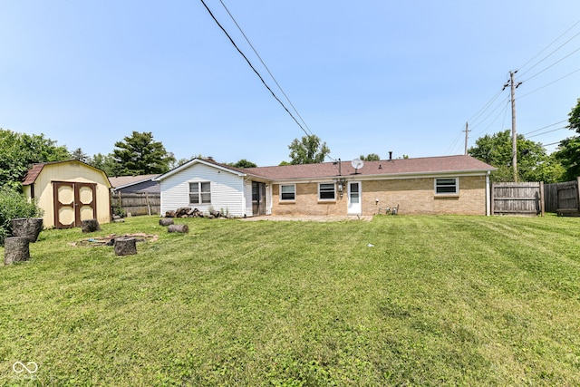 1543 W 79th St, Indianapolis, IN 46260 - rear view of house featuring a fenced backyard, a shed, brick siding, and an outdoor fire pit