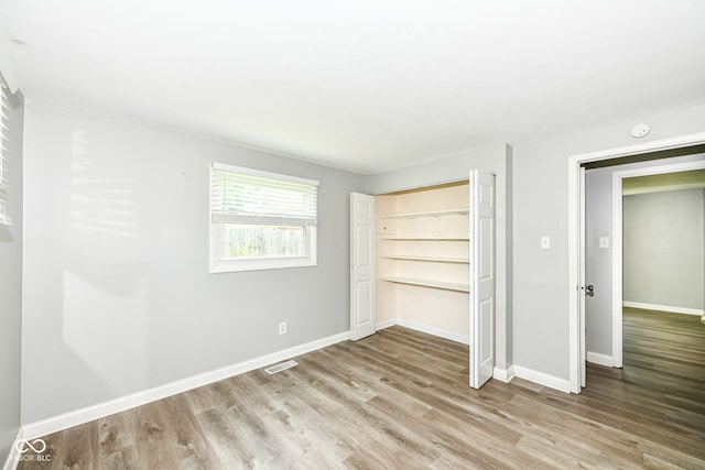 1543 W 79th St, Indianapolis, IN 46260 - unfurnished bedroom featuring wood finished floors and a closet