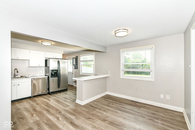 1543 W 79th St, Indianapolis, IN 46260 - kitchen featuring appliances with stainless steel finishes, light wood-style flooring, light countertops, and white cabinets