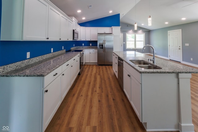 5122 W Legrande Ave, Indianapolis, IN 46241 - kitchen with stainless steel appliances, vaulted ceiling, dark wood-style flooring, white cabinetry, and an island with sink
